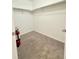 Walk-in closet with neutral carpet, white walls, and chrome clothing racks; a fire extinguisher is mounted near the door at 3029 Merlin Dr, Brighton, CO 80601