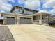 Charming two-story home featuring a three car garage, covered porch and concrete driveway at 3029 Merlin Dr, Brighton, CO 80601