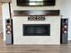 Modern fireplace feature wall with built in speaker system and tile surround at 3029 Merlin Dr, Brighton, CO 80601