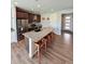 Modern kitchen boasts a large island with granite countertops, seating, and stainless appliances at 3029 Merlin Dr, Brighton, CO 80601