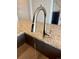 Close up of modern stainless steel faucet and sink on granite countertop at 3029 Merlin Dr, Brighton, CO 80601