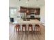 Modern kitchen boasts a large island with granite countertops and stainless steel appliances at 3029 Merlin Dr, Brighton, CO 80601
