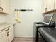 Efficient laundry room showcasing updated appliances and useful storage solutions at 3029 Merlin Dr, Brighton, CO 80601