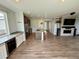 Open concept living area with kitchen island and fireplace feature wall at 3029 Merlin Dr, Brighton, CO 80601