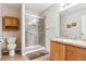 Bathroom features a glass enclosed shower, tile floors, single sink vanity, and neutral tones at 10825 Mount Antero Way, Parker, CO 80138