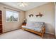 Bedroom features a futon, large window, neutral carpeting, and is staged with minimal decor at 10825 Mount Antero Way, Parker, CO 80138