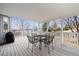 Covered deck with black metal table and chairs, offering an outdoor dining or relaxation space at 10825 Mount Antero Way, Parker, CO 80138