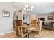Inviting dining area with hardwood floors, chandelier, and view into the living room and front entry at 10825 Mount Antero Way, Parker, CO 80138