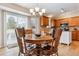 Cozy dining area with a round wooden table, chairs, and sliding doors leading to the backyard at 10825 Mount Antero Way, Parker, CO 80138