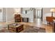 Inviting living room featuring hardwood floors, a leather armchair, and rustic trunk with a natural light at 10825 Mount Antero Way, Parker, CO 80138