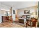 Comfortable living room features a plush couch, wooden chairs, and a cabinet with decorative vase at 10825 Mount Antero Way, Parker, CO 80138