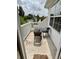 A balcony with a small table and chairs overlooking a quiet street at 8802 E 24Th Pl # 101, Denver, CO 80238