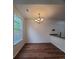 Open dining room with modern lighting, wood floors, and large windows with lots of natural light at 8802 E 24Th Pl # 101, Denver, CO 80238