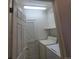 Laundry room with washer, dryer and storage shelves at 8802 E 24Th Pl # 101, Denver, CO 80238