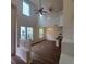 Bright, open living room with high ceilings, lots of windows, and modern ceiling fans at 8802 E 24Th Pl # 101, Denver, CO 80238