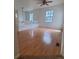 Open loft area with hardwood floors and a view of the front yard at 8802 E 24Th Pl # 101, Denver, CO 80238