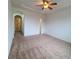 Spacious main bedroom with carpet and archway at 8802 E 24Th Pl # 101, Denver, CO 80238