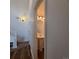 Cozy powder room with pedestal sink and modern light fixture at 8802 E 24Th Pl # 101, Denver, CO 80238