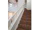 Staircase with carpet runner and white railing leading to the upper level at 8802 E 24Th Pl # 101, Denver, CO 80238