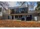 View of the house from backyard, with a patio, grill, and yard covered in fall leaves at 2362 S Troy St, Aurora, CO 80014