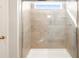 Large walk-in shower with glass enclosure and neutral tile at 570 Red Rock Pl, Brighton, CO 80601