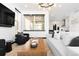Bright living room with modern furnishings, large windows, and stylish decor, creating a welcoming space at 21418 E 61St Dr, Aurora, CO 80019