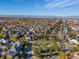 Scenic aerial view of a neighborhood in autumn with colorful trees and city skyline in the distance under blue skies at 8985 E 29Th Pl, Denver, CO 80238