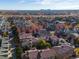 Aerial view of a residential neighborhood showcasing well-maintained homes and landscaping with mature trees and a clear sky at 8985 E 29Th Pl, Denver, CO 80238