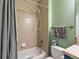 Bathroom featuring tiled shower and tub combination with gray shower curtain at 8985 E 29Th Pl, Denver, CO 80238
