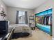 Bedroom featuring a bed, desk, and closet with organized storage and clothes at 8985 E 29Th Pl, Denver, CO 80238