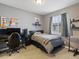 Bedroom with a desk setup, gray walls, window, and a bed with polka dot bedding at 8985 E 29Th Pl, Denver, CO 80238