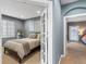 Comfortable bedroom with natural light, neutral tones, open French doors, and views into the home at 8985 E 29Th Pl, Denver, CO 80238