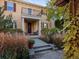 Inviting home exterior features a charming front porch with chairs and a second-story balcony at 8985 E 29Th Pl, Denver, CO 80238