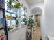 Hallway featuring archways, plants, bright light, and lots of cozy decor at 8985 E 29Th Pl, Denver, CO 80238