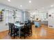 Open-concept kitchen and dining area featuring light gray cabinets, an island, and a window with plants at 8985 E 29Th Pl, Denver, CO 80238
