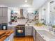 Stylish kitchen featuring a blue oven, white subway tile backsplash, and open shelving with decor at 8985 E 29Th Pl, Denver, CO 80238