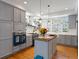 Bright kitchen with gray cabinetry, a blue oven, and a butcher block island, perfect for cooking at 8985 E 29Th Pl, Denver, CO 80238