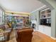 Cozy living room with a fireplace, built-in bookshelves, and ample natural light at 8985 E 29Th Pl, Denver, CO 80238