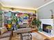 Living room featuring built-in bookshelves, a cozy fireplace, and hardwood floors at 8985 E 29Th Pl, Denver, CO 80238