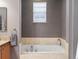 Bathroom featuring bathtub with tile surround and window at 8985 E 29Th Pl, Denver, CO 80238