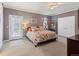 Cozy bedroom with a floral bedspread and walk out door at 8985 E 29Th Pl, Denver, CO 80238