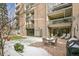 Community patio with seating, grill, and snowy landscaping at 2000 E 12Th Ave # 15D, Denver, CO 80206