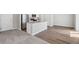 Open-concept living area featuring sleek flooring, a kitchen with granite countertops, and ample natural light at 7307 Dolores Ave, Frederick, CO 80530