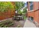 Private backyard featuring a round table, chairs, and beautiful landscaping for outdoor enjoyment at 836 E 17Th Ave # 1A, Denver, CO 80218