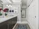 A luxury bathroom featuring a double vanity, grey cabinets, and hexagonal tile floors at 836 E 17Th Ave # 1A, Denver, CO 80218