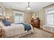 Bright bedroom with hardwood floors, neutral paint, and a dresser with vintage lamp at 836 E 17Th Ave # 1A, Denver, CO 80218