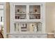 A close up of an elegant built-in cabinet with glass doors and mirrored back at 836 E 17Th Ave # 1A, Denver, CO 80218