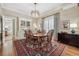 Elegant dining room featuring a classic wood table, built-in display cabinet, and an ornate ceiling fixture at 836 E 17Th Ave # 1A, Denver, CO 80218
