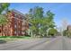 Classic brick building with mature trees lining the street, situated near downtown at 836 E 17Th Ave # 1A, Denver, CO 80218