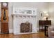 Classic fireplace with marble surround, decorative screen, and vintage clock at 836 E 17Th Ave # 1A, Denver, CO 80218